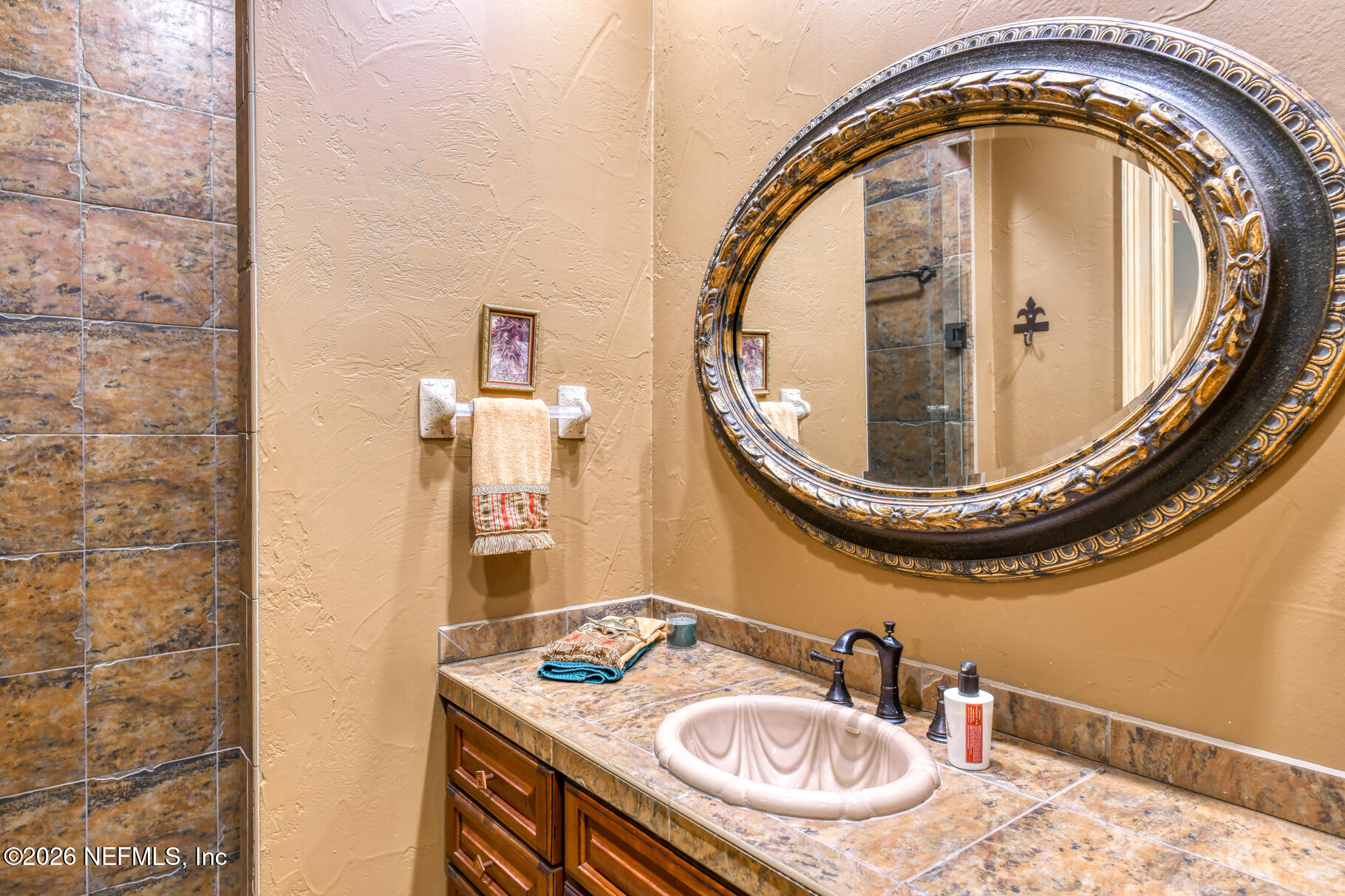 131 Whitney Street Satsuma, FL 32189 - Photo 28 of 75 a bathroom with a sink and a mirror