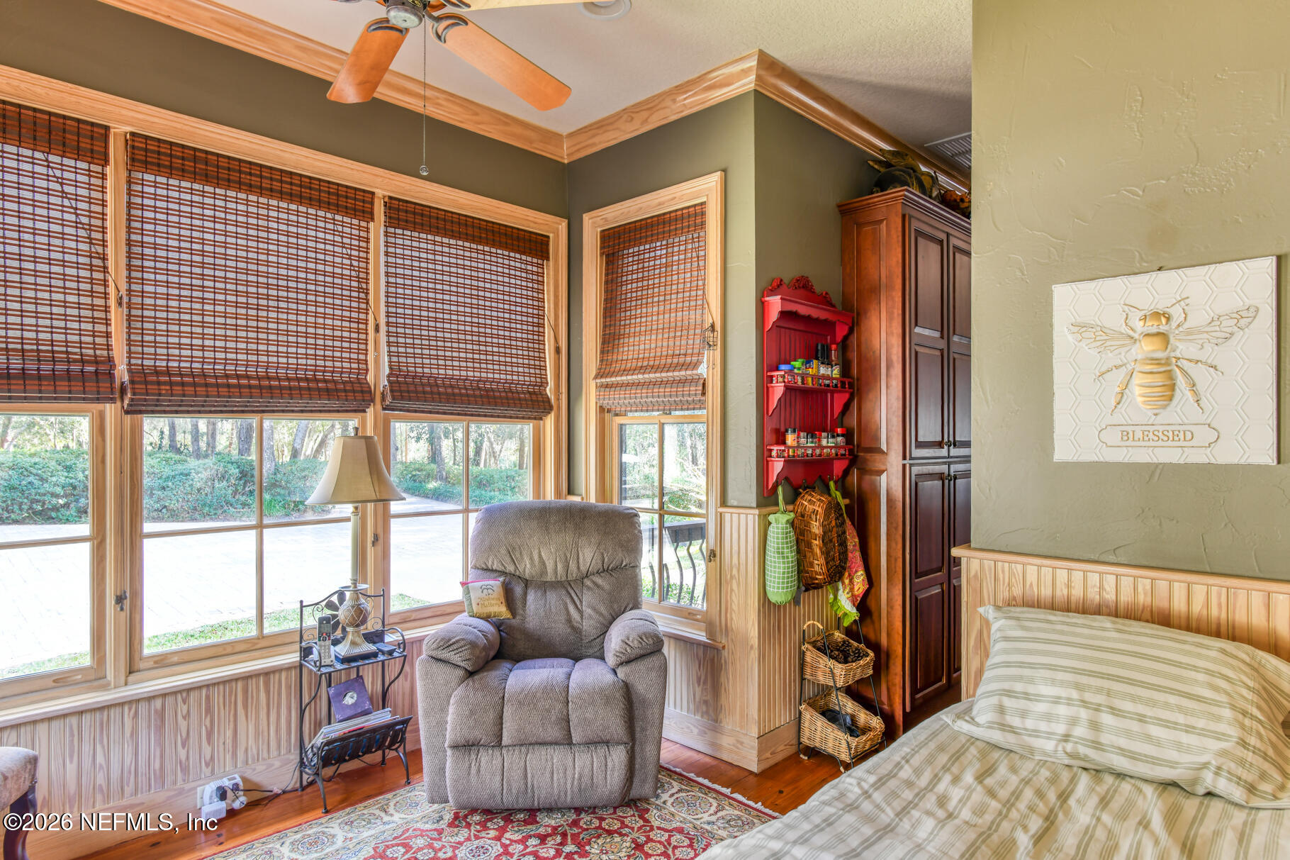 131 Whitney Street Satsuma, FL 32189 - Photo 30 of 75 a living room with furniture a flat screen tv and a large window