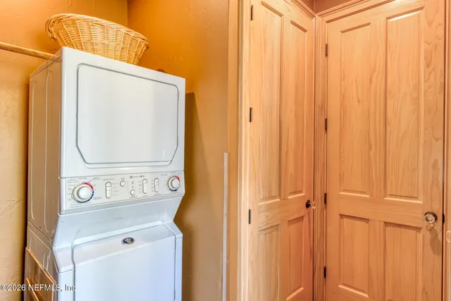 a view of a deck with two trees and wooden fence
