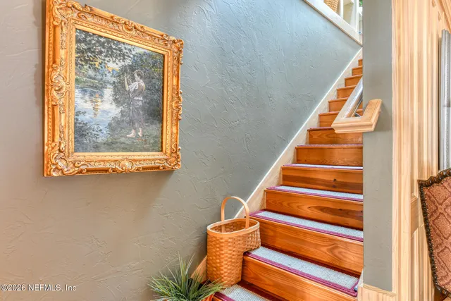 a view of a house with fountain and a large tree