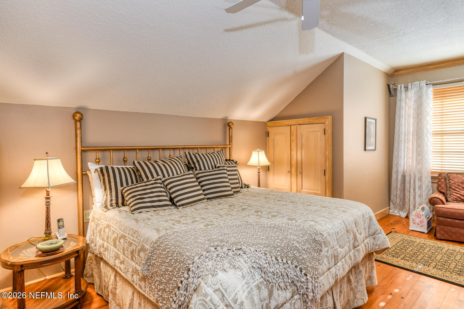 131 Whitney Street Satsuma, FL 32189 - Photo 34 of 75 a bedroom with a bed and wooden floor