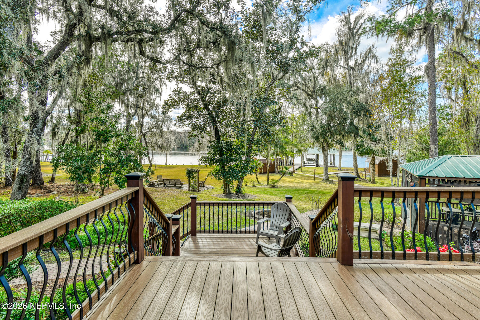 131 Whitney Street Satsuma, FL 32189 - Photo 40 of 75 a view of a deck with two trees and wooden fence