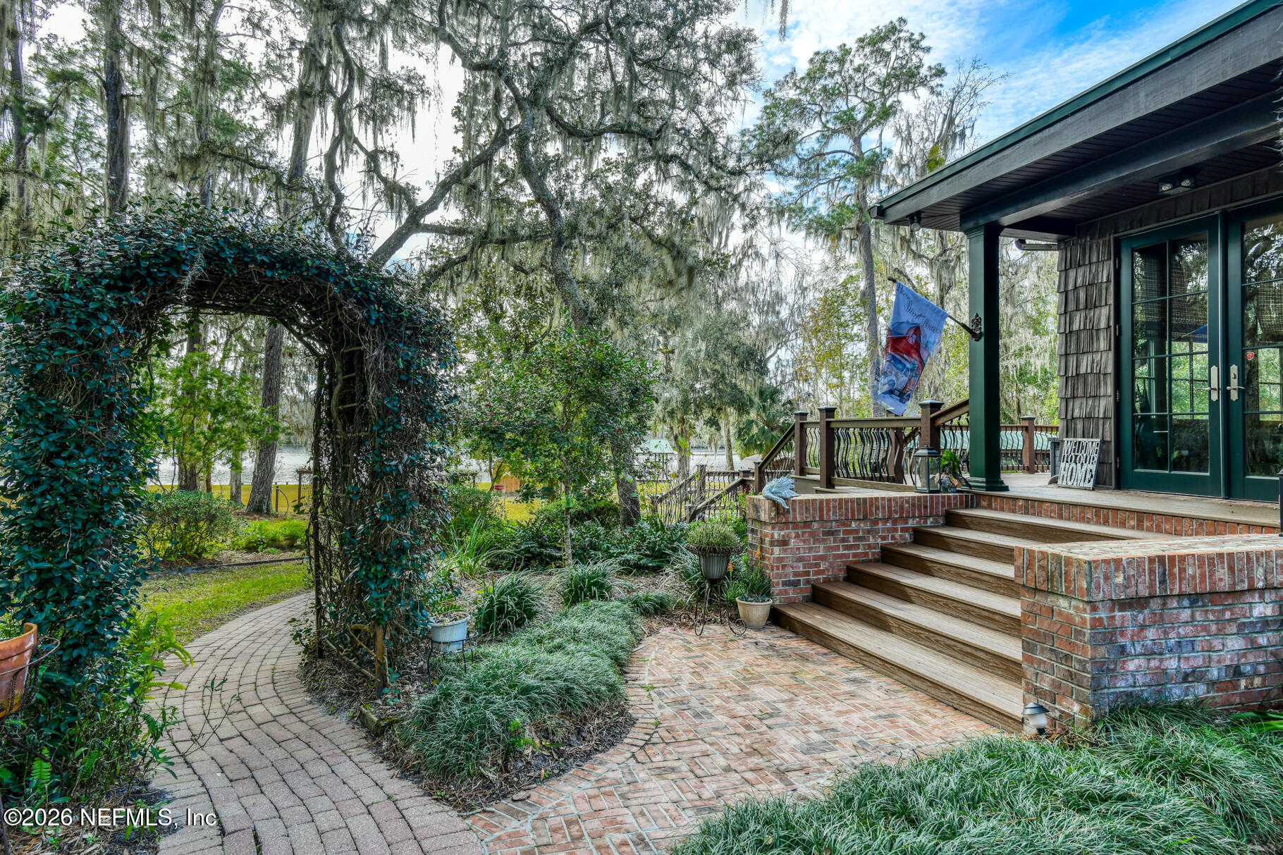 131 Whitney Street Satsuma, FL 32189 - Photo 41 of 75 a view of a house with fountain and a large tree