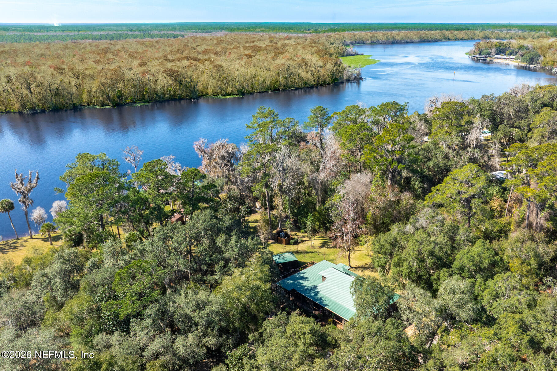 131 Whitney Street Satsuma, FL 32189 - Photo 71 of 75 a view of a lake with houses in the back