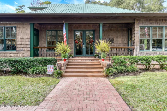 a kitchen with stainless steel appliances granite countertop a table chairs sink refrigerator and cabinets