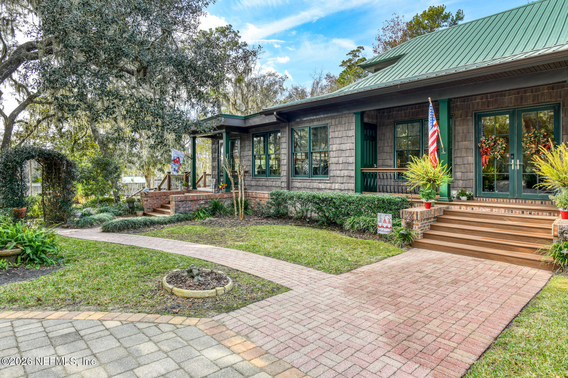 131 Whitney Street Satsuma, FL 32189 - Photo 9 of 75 a front view of a house with garden and porch