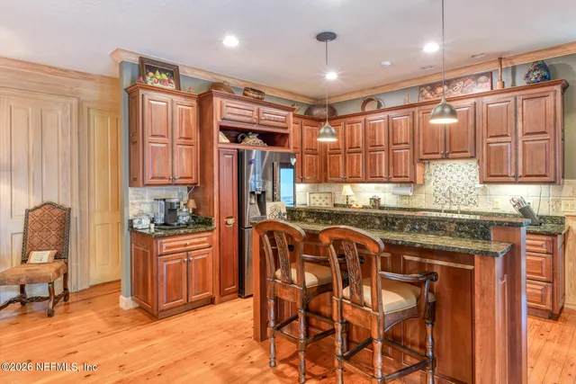 a kitchen with stainless steel appliances granite countertop a sink stove and cabinets