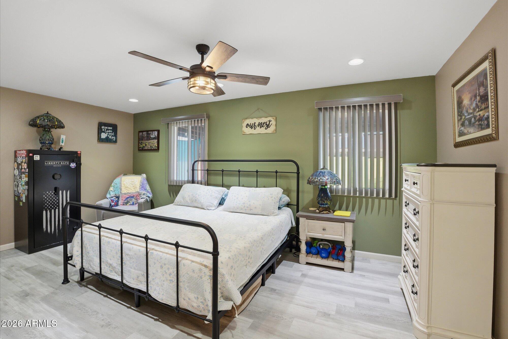 2222 West Maple Drive Phoenix, AZ 85027 - Photo 11 of 32 a bedroom with a bed next to a window with a flat screen tv