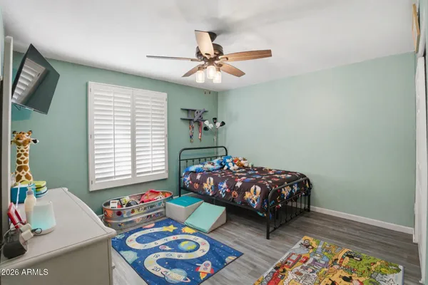 a bed room with a bed mirror and a window