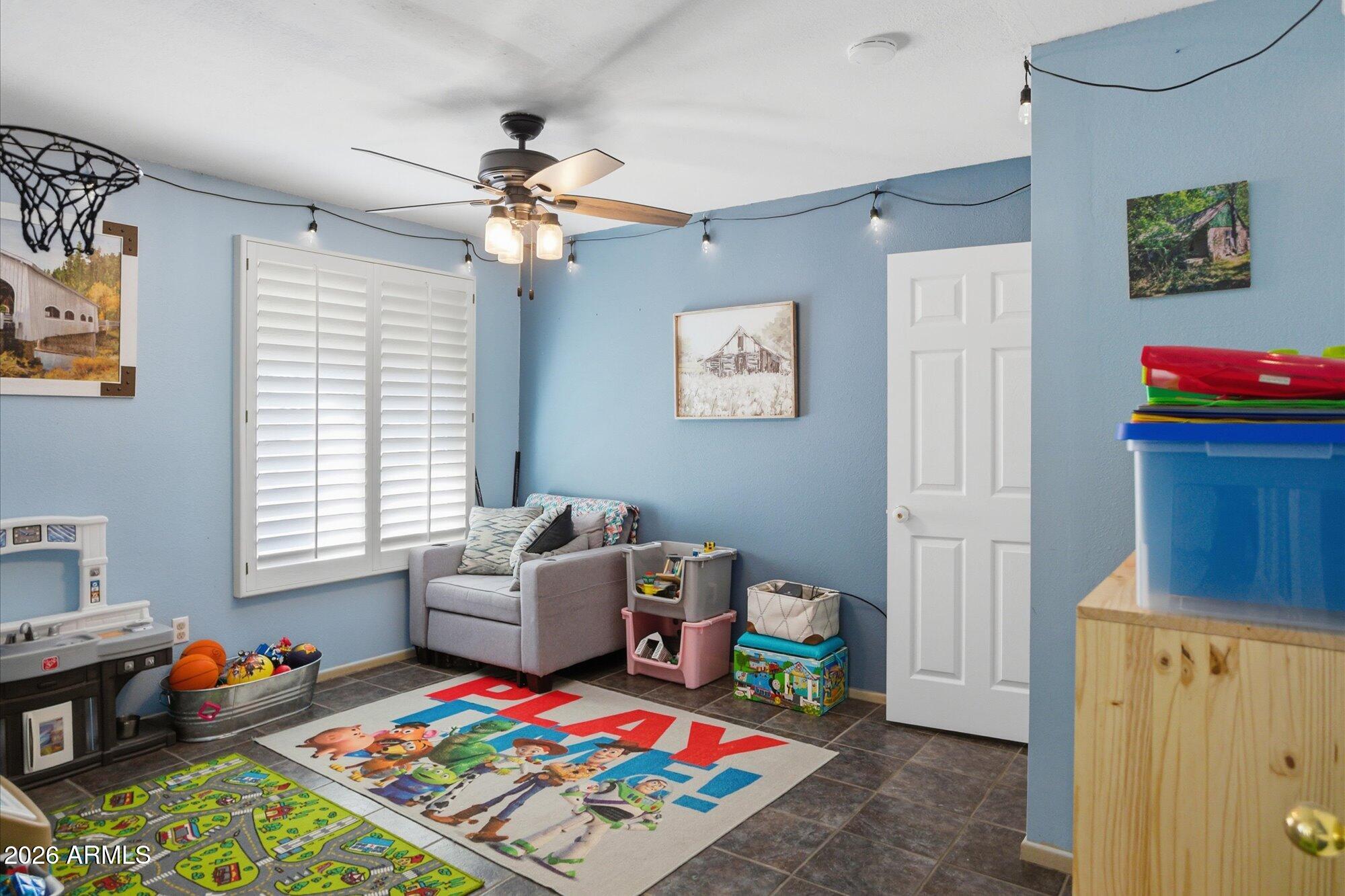 2222 West Maple Drive Phoenix, AZ 85027 - Photo 16 of 32 a living room with baby crib furniture and a window