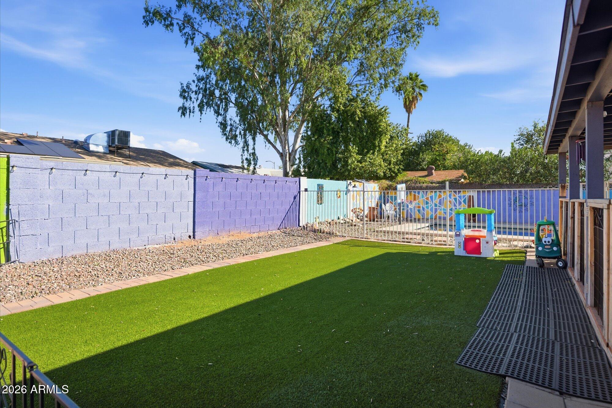 2222 West Maple Drive Phoenix, AZ 85027 - Photo 22 of 32 a view of a deck with a big yard potted plants and large tree