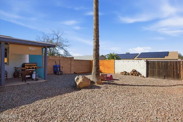 a backyard of a house with table and chairs