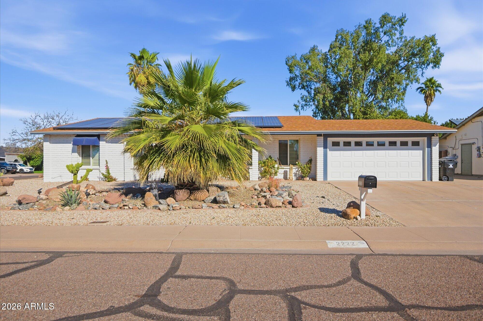 2222 West Maple Drive Phoenix, AZ 85027 - Photo 29 of 32 a view of a swimming pool with a lawn chairs under an umbrella