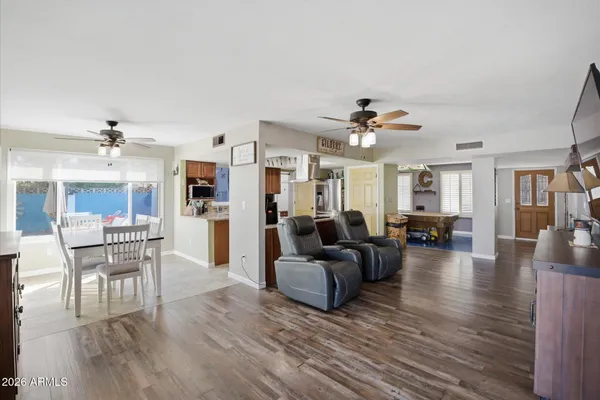 a living room with furniture and a wooden floor