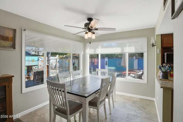 a view of a dining room with furniture a chandelier and wooden floor