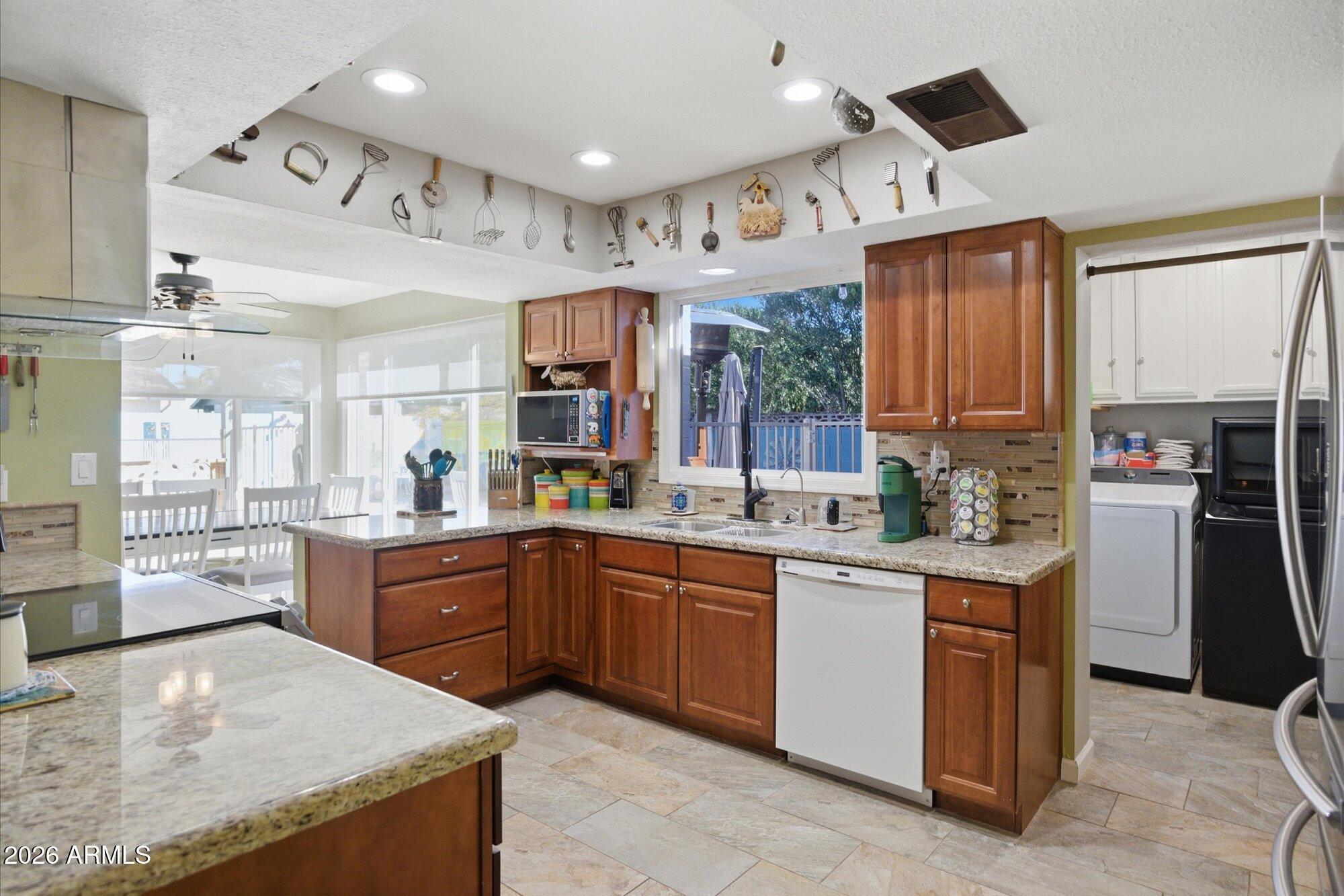 2222 West Maple Drive Phoenix, AZ 85027 - Photo 8 of 32 a kitchen with stainless steel appliances granite countertop a sink and cabinets
