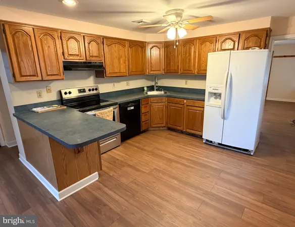 a kitchen with a stove a sink and a refrigerator