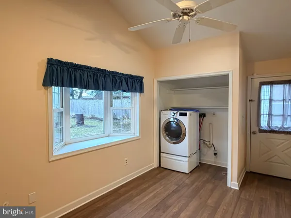 a utility room with a window and a chandelier