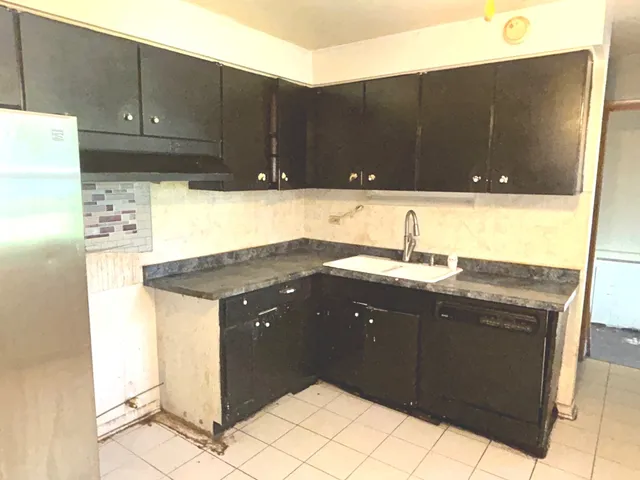 a kitchen with a sink and cabinets
