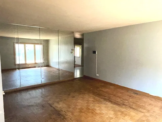 a view of a kitchen with a cabinet and mirrors