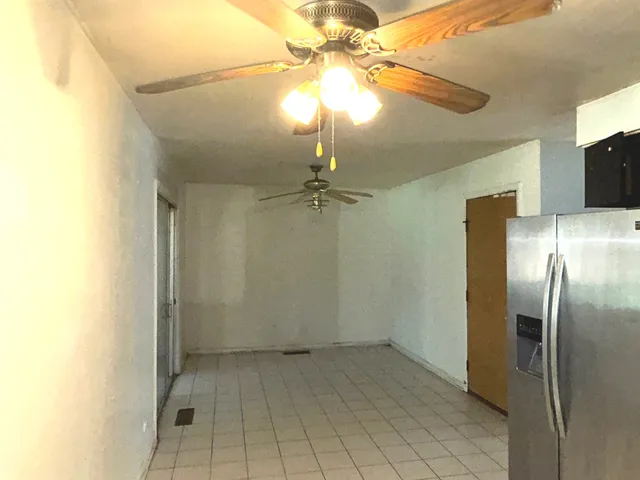 a view of a livingroom with a chandelier fan