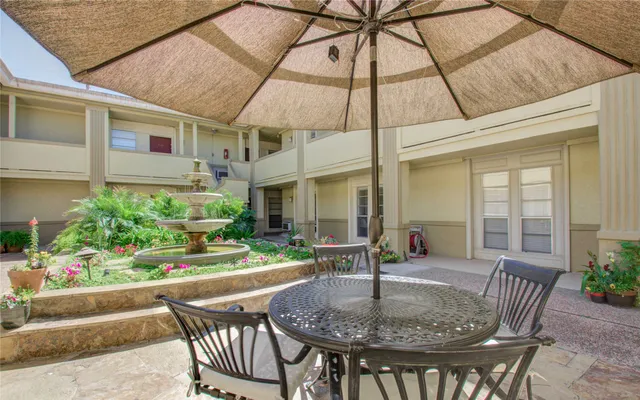 a patio with a table and chairs