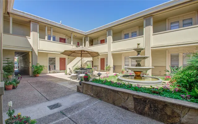 a front view of a house with swimming pool and sitting area
