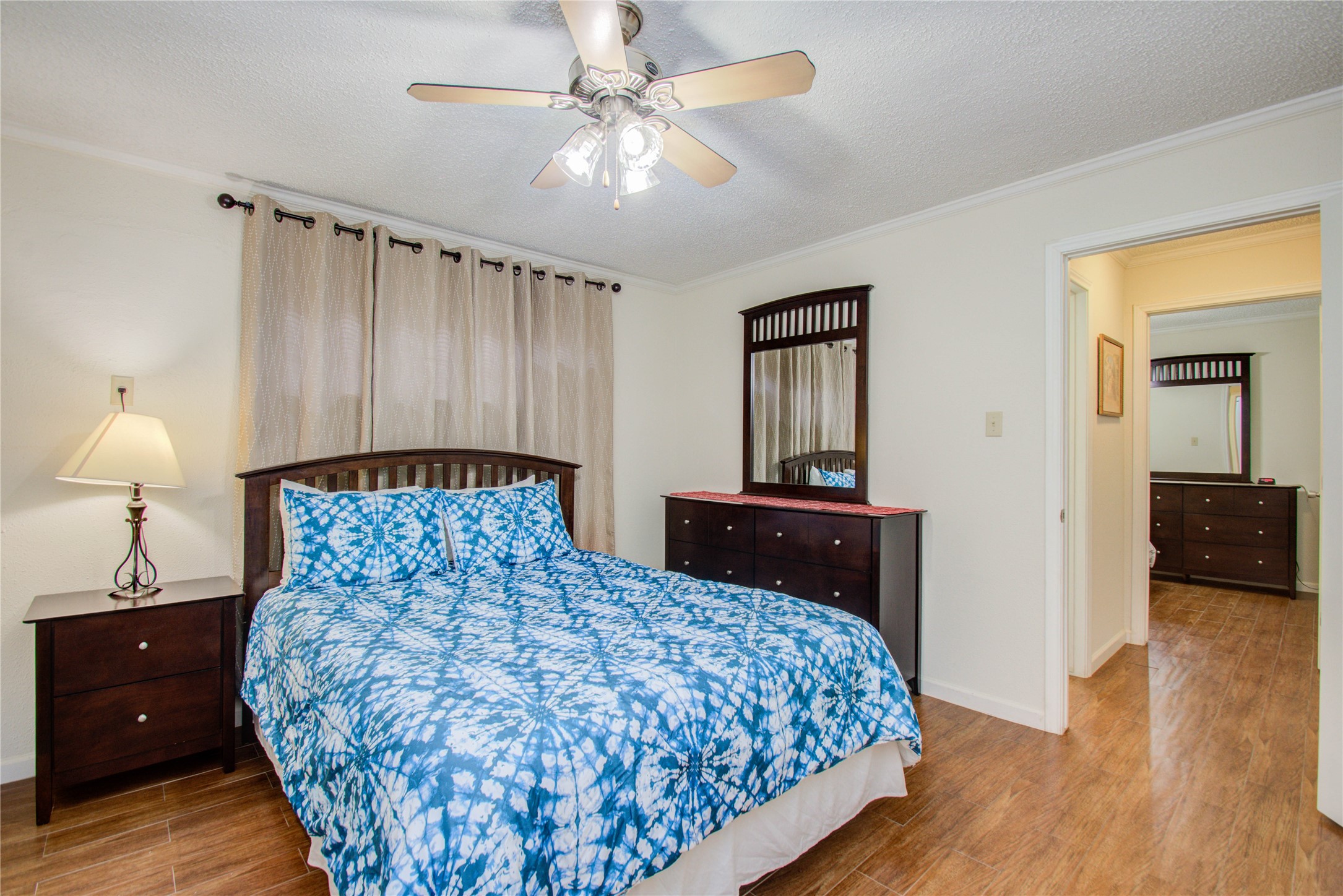 4727 West Alabama Street, Unit 2214 Houston, TX 77027 - Photo 7 of 11 a bedroom with a bed and a chandelier