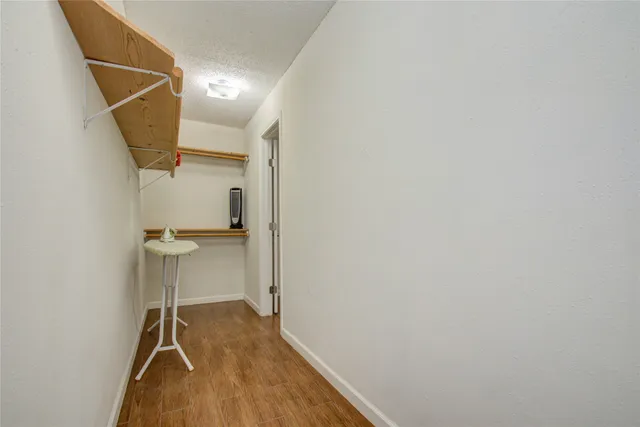 a view of a room with wooden floor