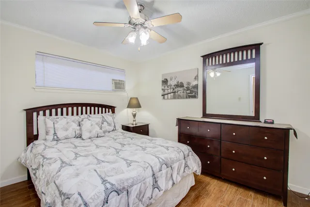 a bedroom with a large bed and a dresser