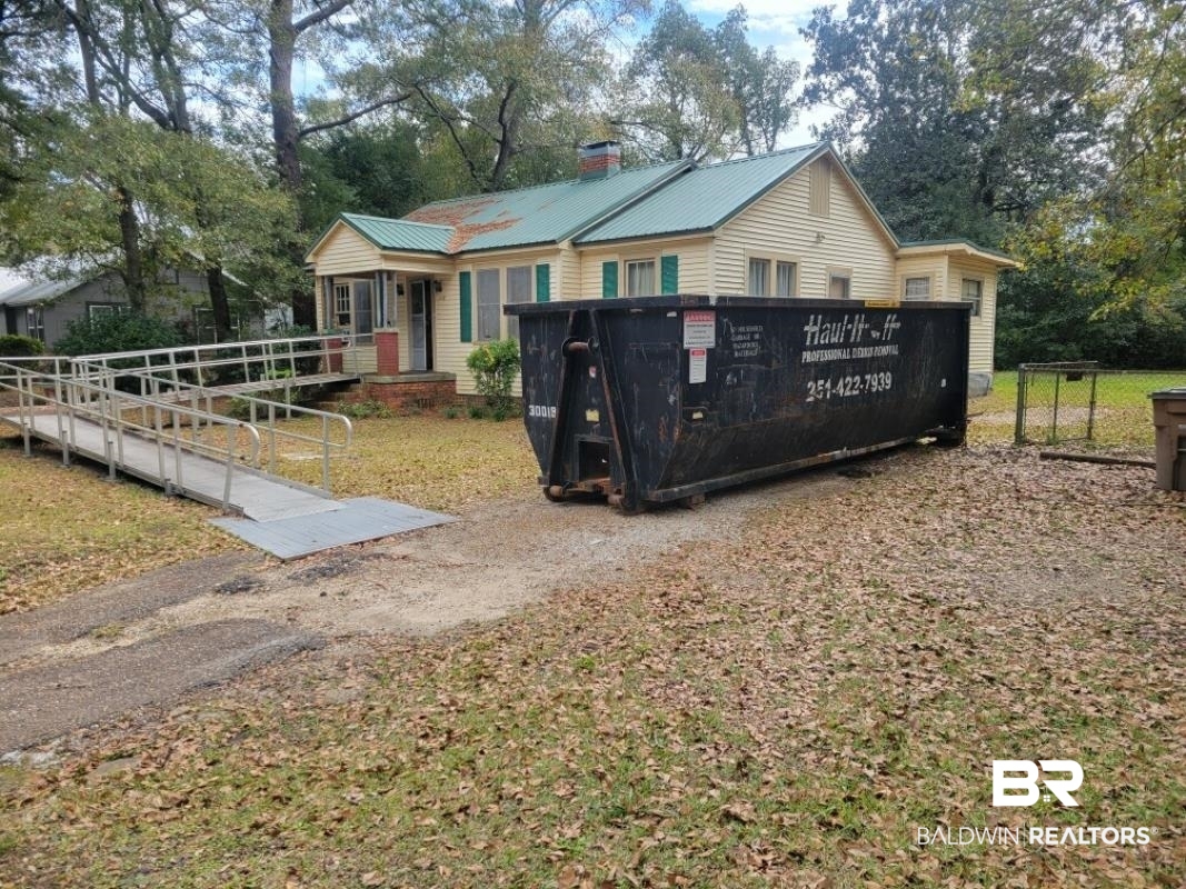 2059 Magnolia Lane Mobile, AL 36605 - Photo 1 of 17 View of front of house with metal roof and a chimney