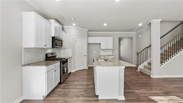 a large kitchen with stainless steel appliances lots of counter top space and cabinets
