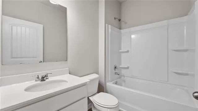 a bathroom with a bathtub shower sink vanity mirror and toilet