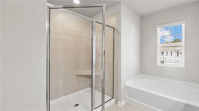 a bathroom with a bathtub and a shower