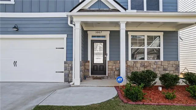 a view of a brick house with potted plants