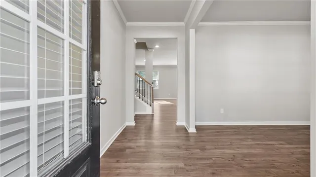 a view of hallway with wooden floor