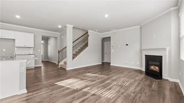 a view of empty room with wooden floor and fireplace