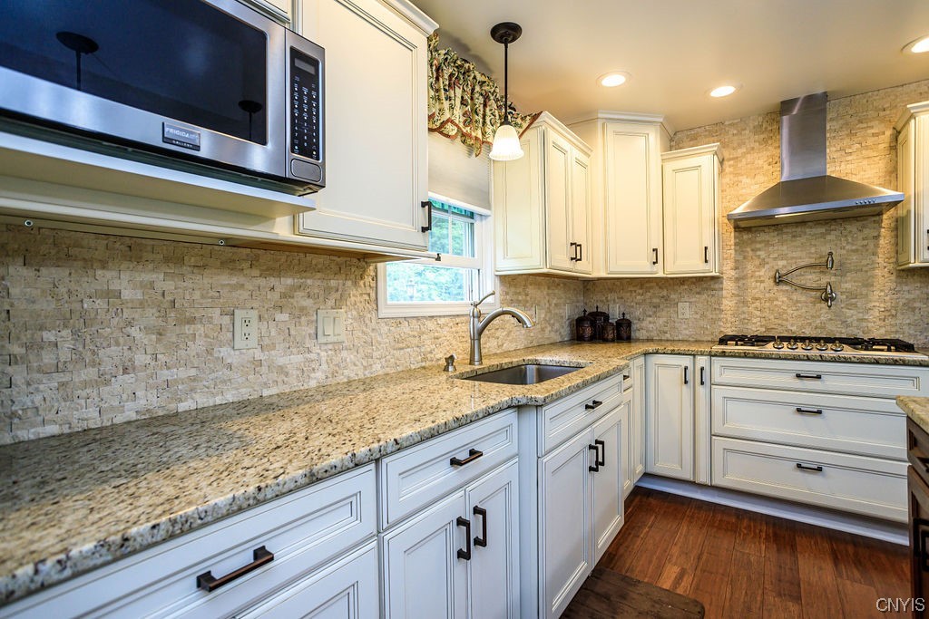 1399 Berry Road Fabius, NY 13084 - Photo 13 of 49 Exquisite backsplash, stylish range hood and of co