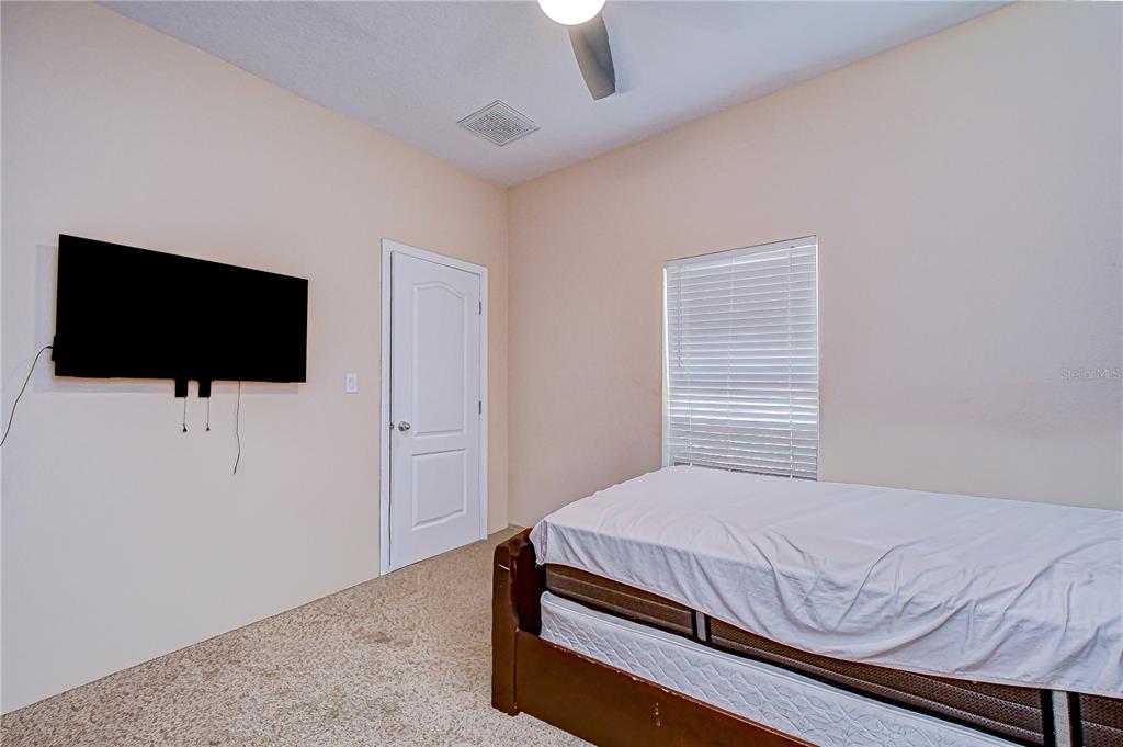 4036 Moores Lake Road Dover, FL 33527 - Photo 13 of 18 a bedroom with a bed and a flat screen tv