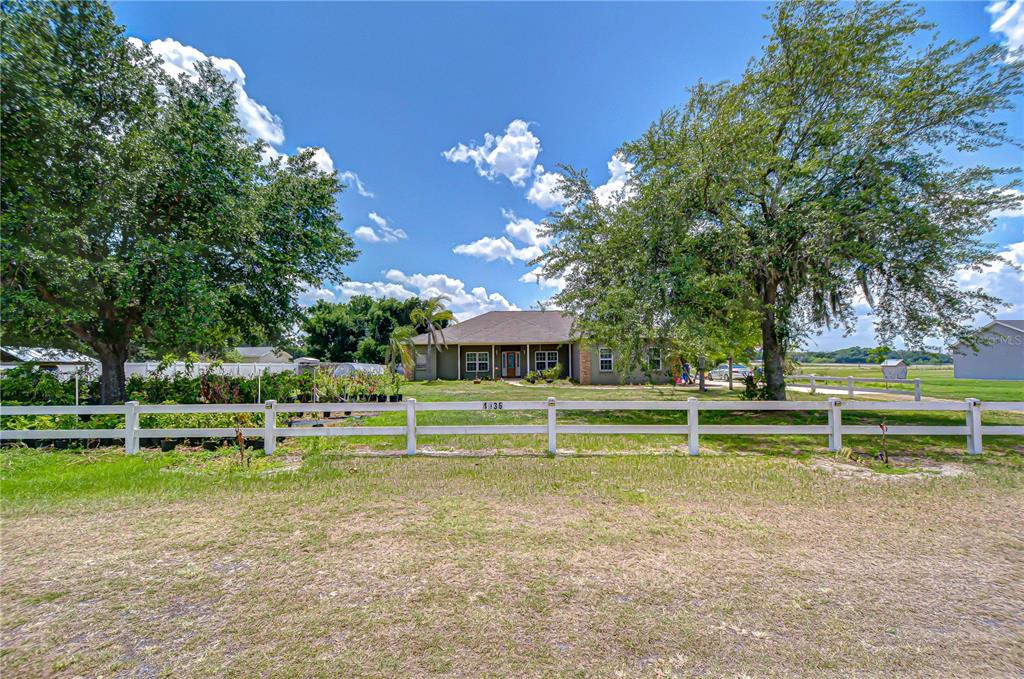 4036 Moores Lake Road Dover, FL 33527 - Photo 18 of 18 a view of a swimming pool with a house in the background