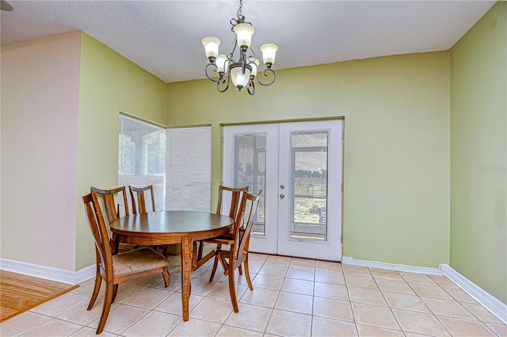 4036 Moores Lake Road Dover, FL 33527 - Photo 9 of 18 a view of a dining room with furniture and chandelier