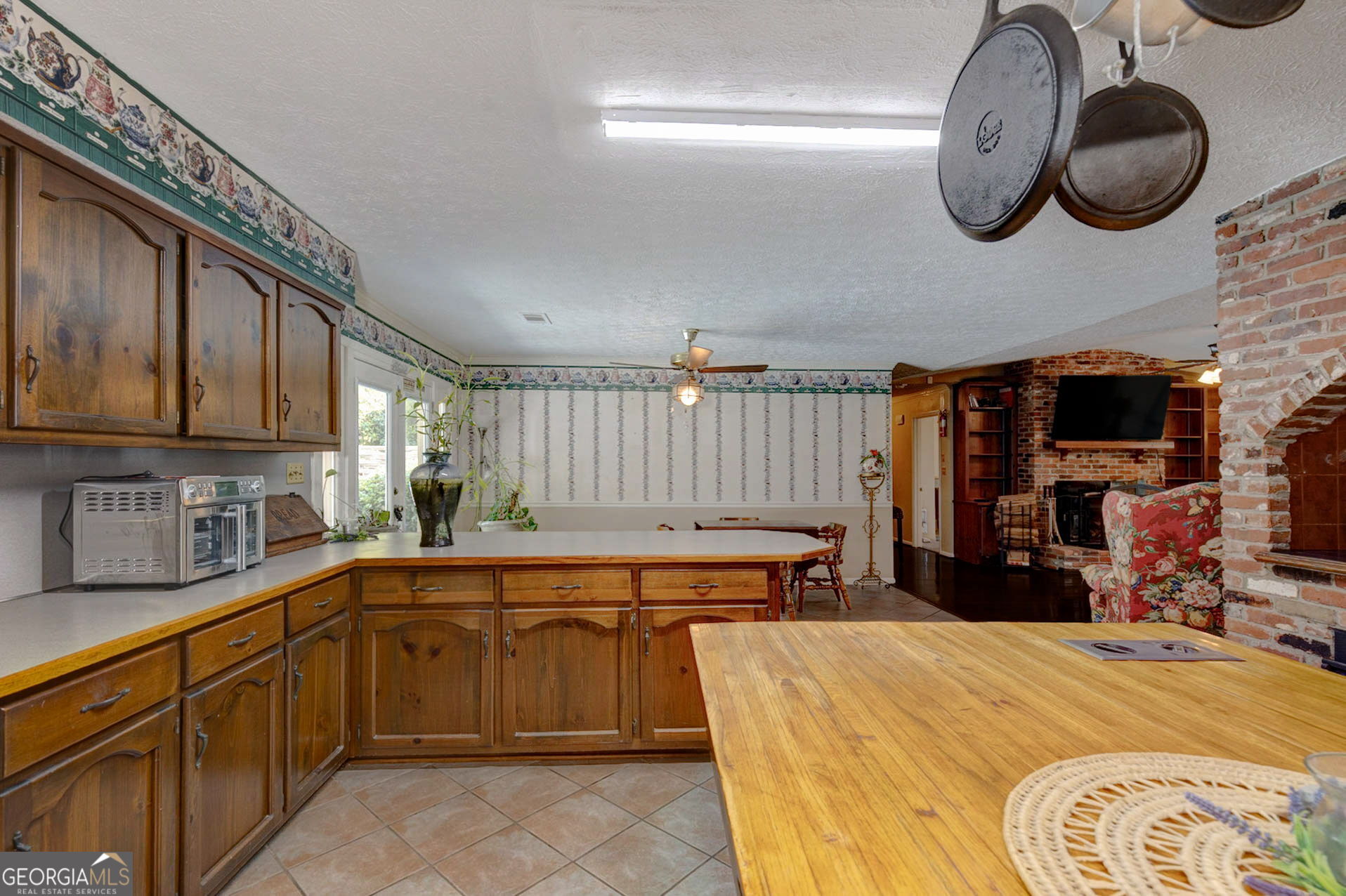 994 Highway 315 Fortson, GA 31808 - Photo 11 of 46 a kitchen that has a lot of cabinets and wooden floor