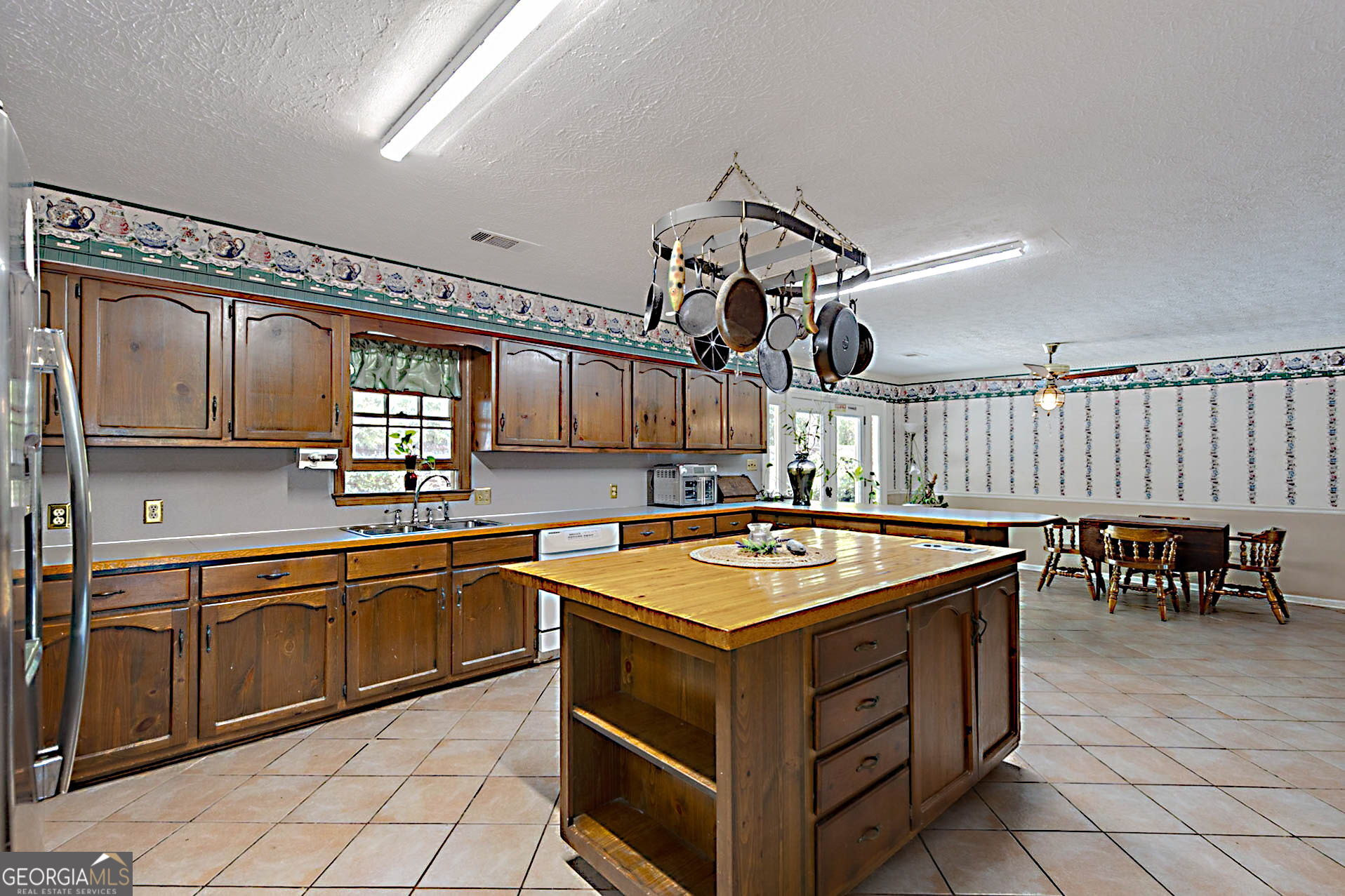 994 Highway 315 Fortson, GA 31808 - Photo 13 of 46 a kitchen with a stove a sink and a refrigerator