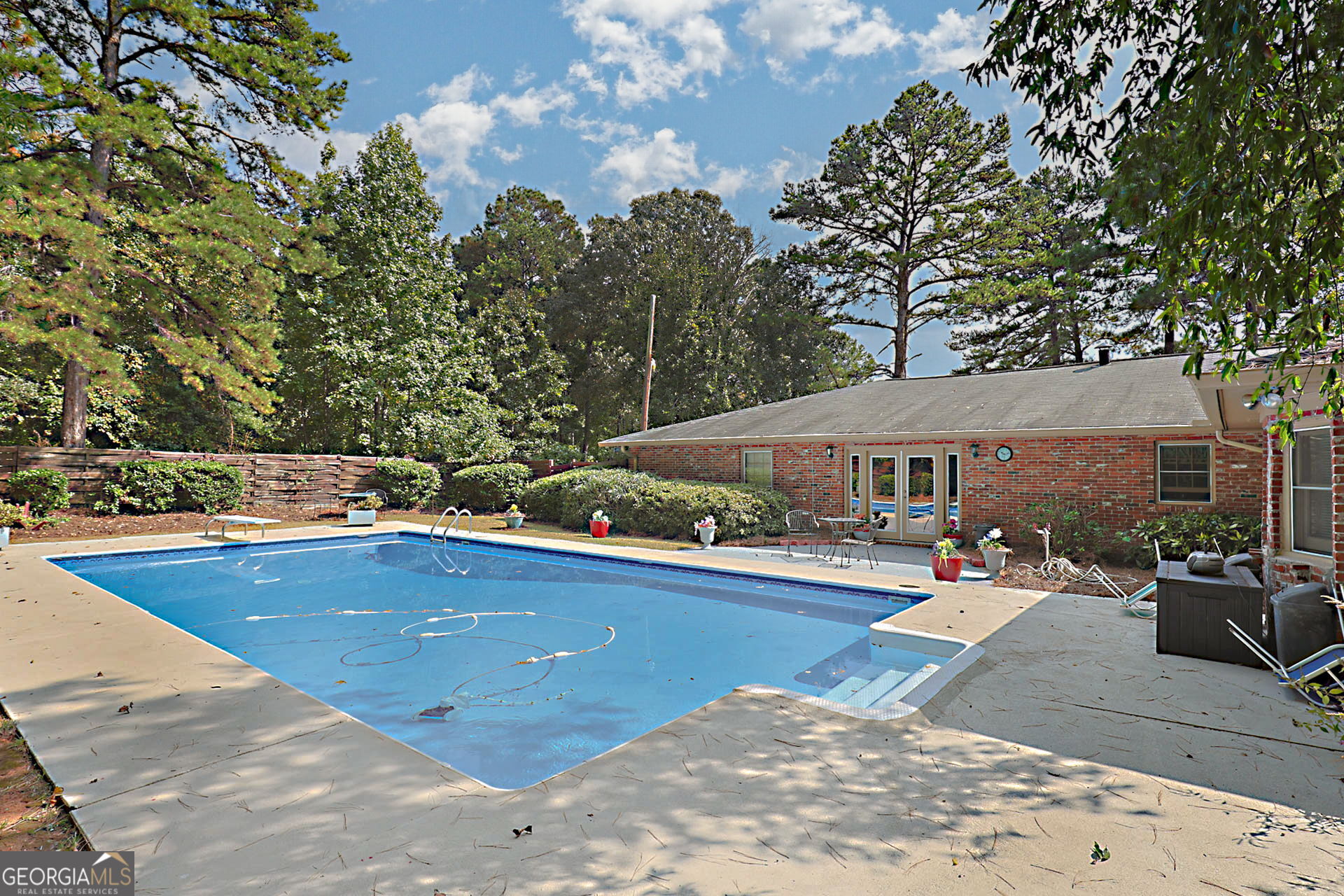 994 Highway 315 Fortson, GA 31808 - Photo 33 of 46 a view of swimming pool with outdoor seating and trees in the background