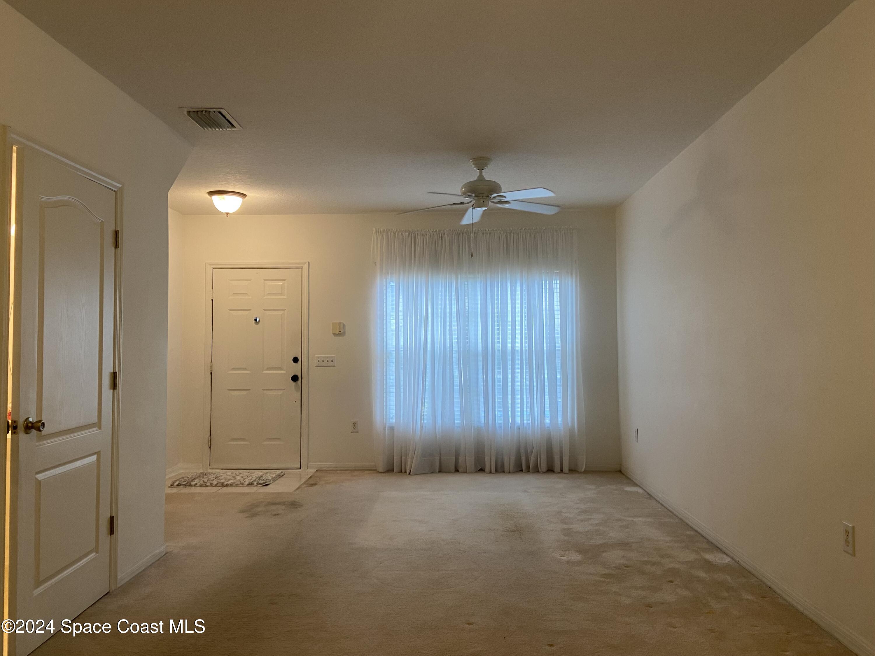1420 Hampton Park Lane Melbourne, FL 32940 - Photo 2 of 20 an empty room with windows and closet
