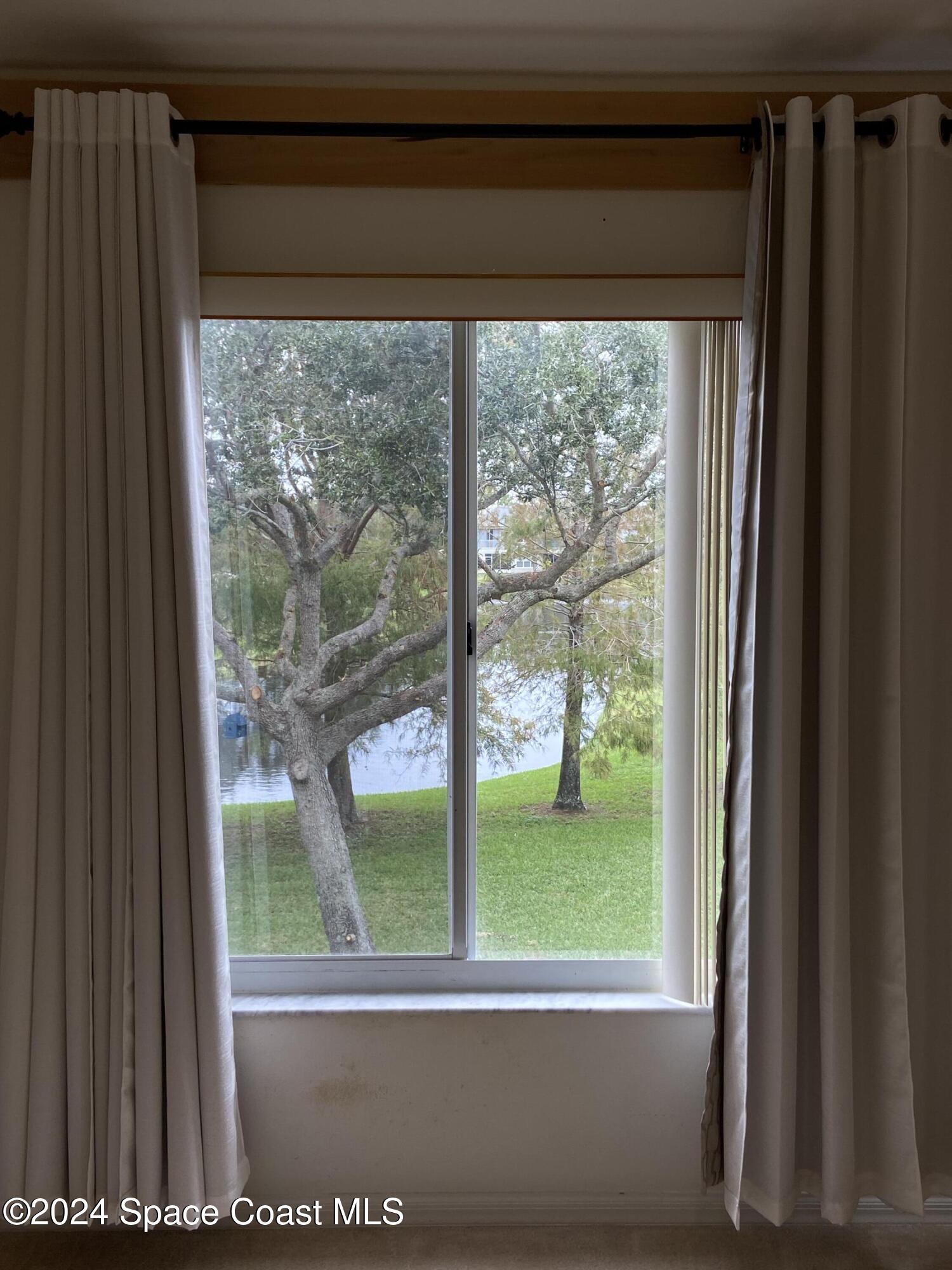 1420 Hampton Park Lane Melbourne, FL 32940 - Photo 8 of 20 a view of a room that has a large window and front view