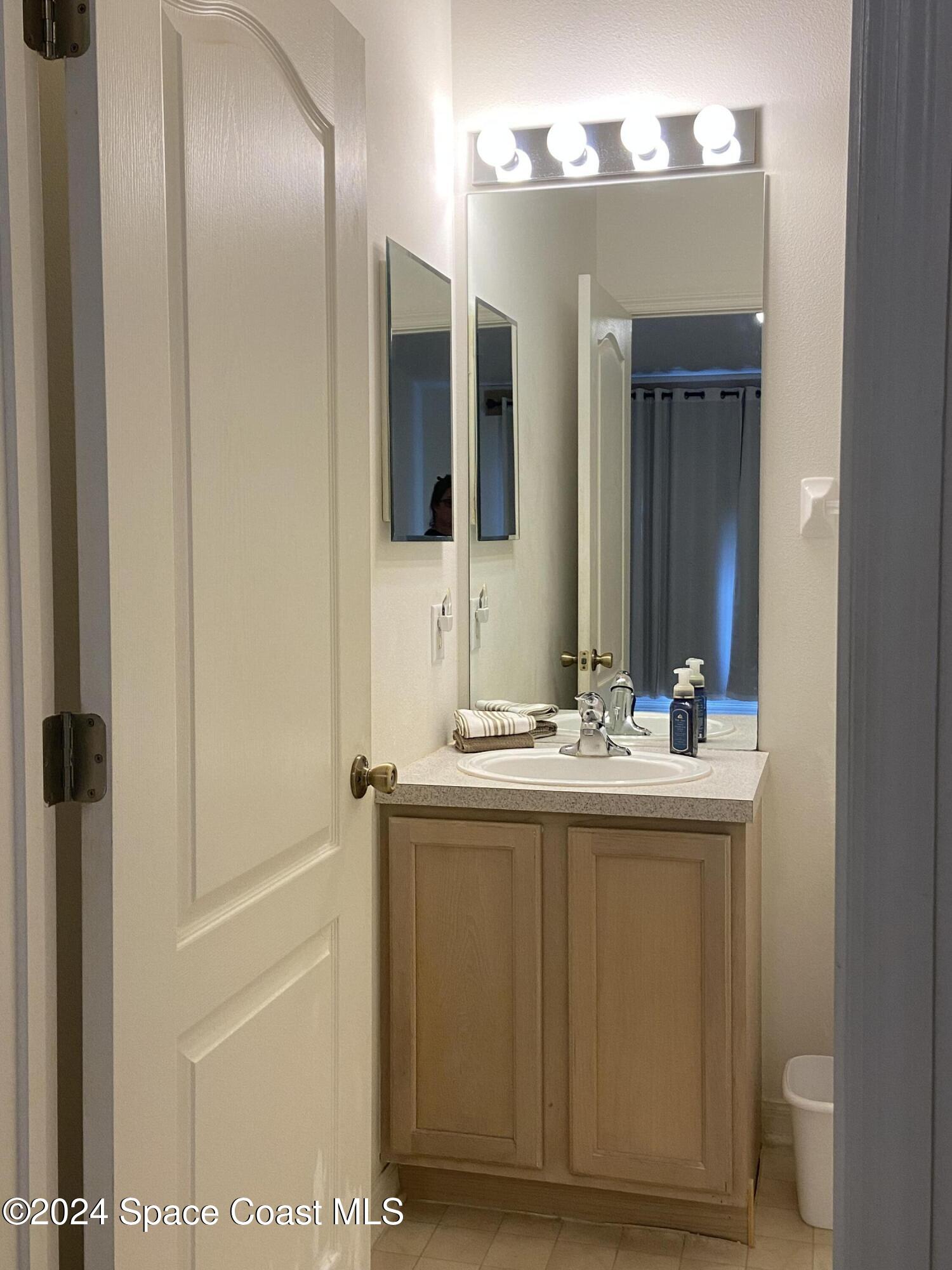 1420 Hampton Park Lane Melbourne, FL 32940 - Photo 9 of 20 a bathroom with a sink and a mirror