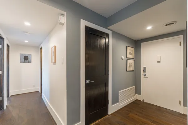a view of hallway with wooden floor