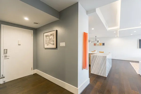 a view of hallway with wooden floor