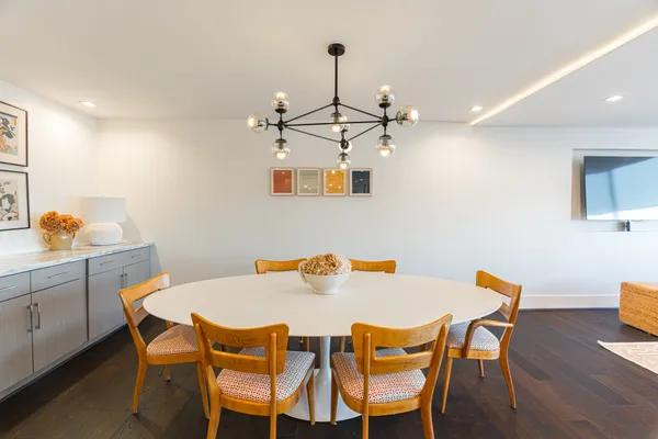 a view of a dining room with furniture and wooden floor